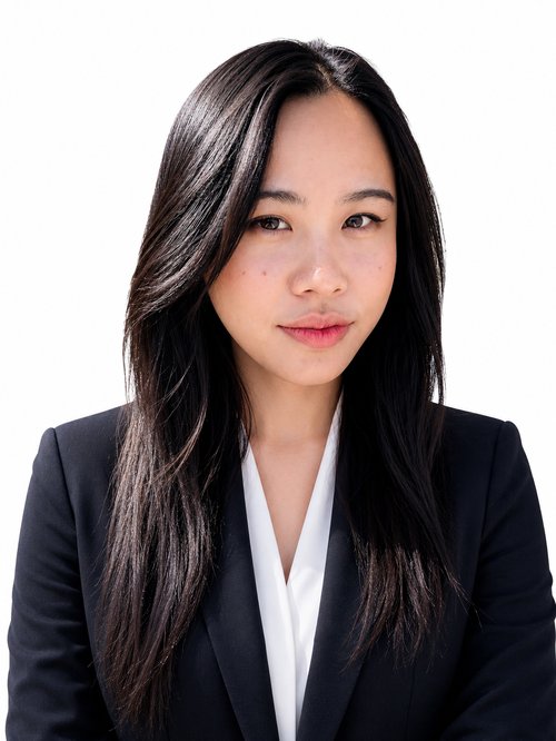 Professional headshot of Bich Nguyen, smiling, wearing a dark blazer over a white blouse.